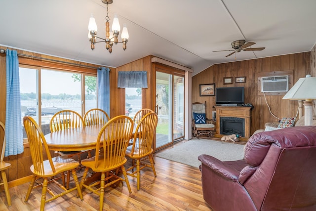 13506 Elmer Hanson Dr SE, Woodside Twp, MN 56736 - dining area featuring an AC wall unit, lofted ceiling, wooden walls, a chandelier, and ceiling fan