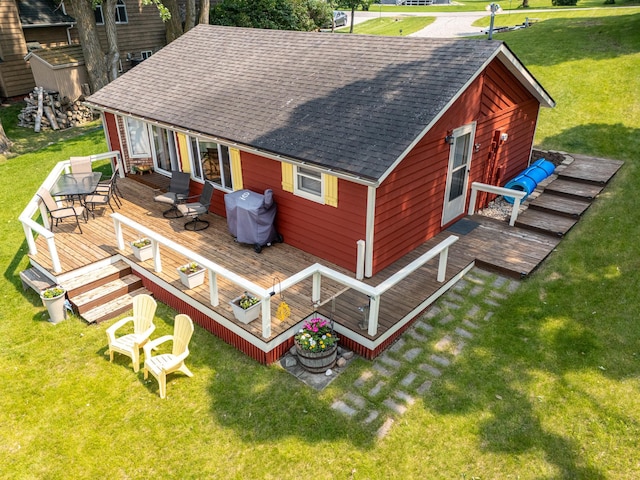 13506 Elmer Hanson Dr SE, Woodside Twp, MN 56736 - back of house with roof with shingles, a deck, and a lawn