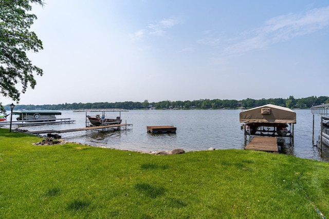 13506 Elmer Hanson Dr SE, Woodside Twp, MN 56736 - dock featuring boat lift, a lawn, and a water view