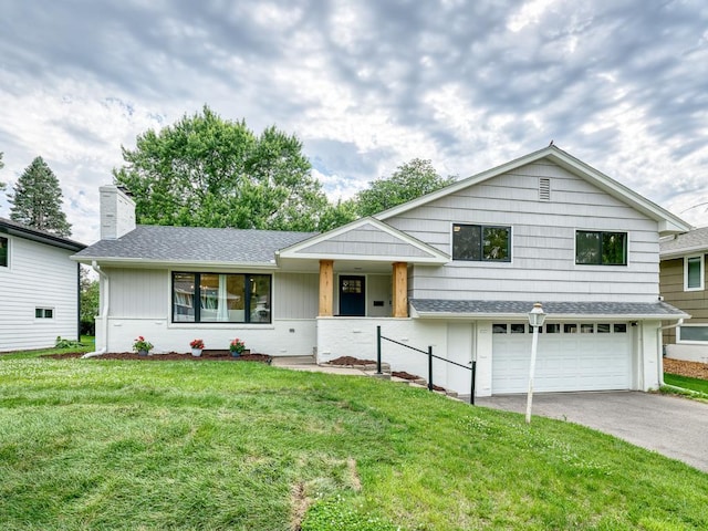 4909 Trillium Ln, Edina, MN 55435 - split level home featuring a chimney, a garage, asphalt driveway, a front yard, and roof with shingles