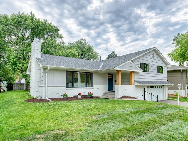 4909 Trillium Ln, Edina, MN 55435 - split level home featuring asphalt driveway, a chimney, an attached garage, and roof with shingles