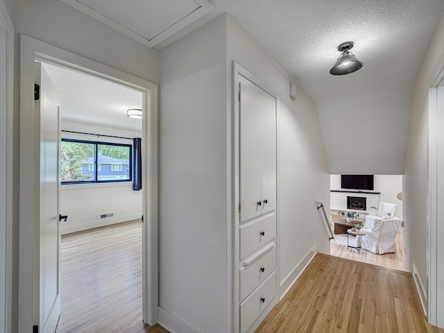 4909 Trillium Ln, Edina, MN 55435 - hallway with light wood-style floors and a textured ceiling