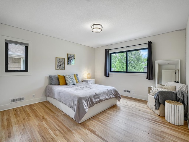 4909 Trillium Ln, Edina, MN 55435 - bedroom featuring light wood finished floors and a textured ceiling