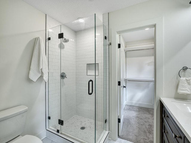 4909 Trillium Ln, Edina, MN 55435 - bathroom featuring a stall shower, vanity, and a textured ceiling