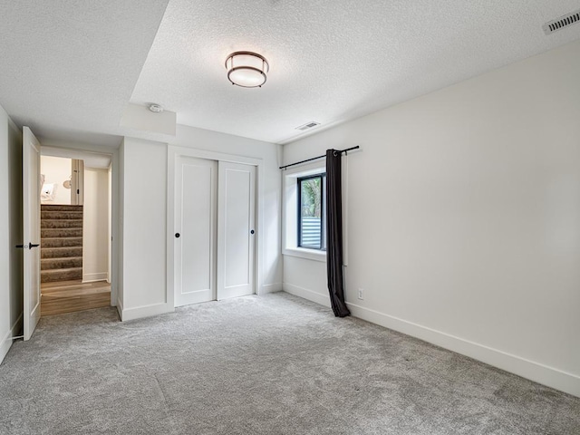 4909 Trillium Ln, Edina, MN 55435 - unfurnished bedroom with a textured ceiling, carpet, and a closet