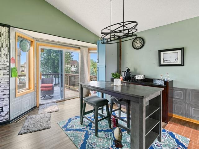 1813 Canton Rd, Prescott, WI 54021 - dining area with vaulted ceiling, a chandelier, and wood finished floors