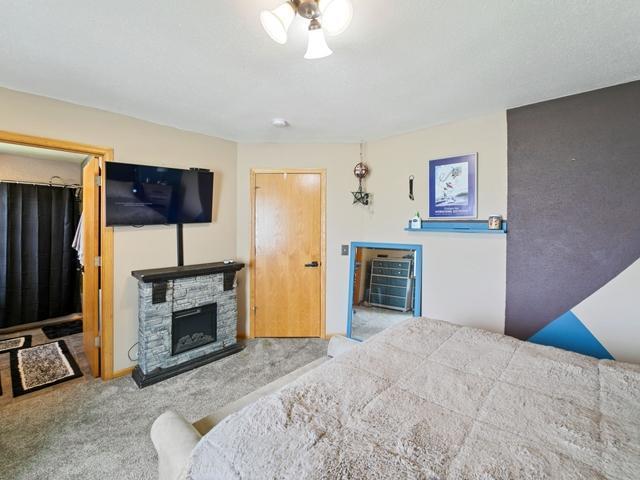 1813 Canton Rd, Prescott, WI 54021 - carpeted bedroom with a fireplace