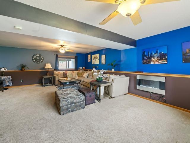 1813 Canton Rd, Prescott, WI 54021 - living room featuring carpet, a ceiling fan, and heating unit