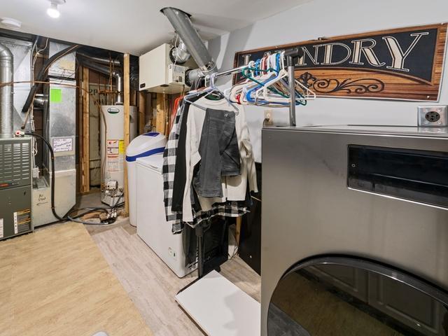 1813 Canton Rd, Prescott, WI 54021 - utility room with gas water heater, washer and clothes dryer, and heating unit