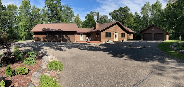 8916 Kabekona Springs Dr NW, Walker, MN 56484 - view of front facade featuring a detached garage and a chimney