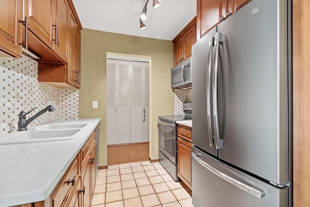 2801 Flag Ave N Unit 314, New Hope, MN 55427 - kitchen featuring appliances with stainless steel finishes, tasteful backsplash, light countertops, and light tile patterned floors