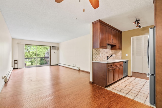 2801 Flag Ave N Unit 314, New Hope, MN 55427 - kitchen featuring a baseboard radiator, stainless steel appliances, a ceiling fan, open floor plan, and light wood-type flooring