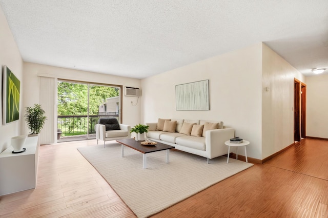 2801 Flag Ave N Unit 314, New Hope, MN 55427 - living room with wood finished floors, a textured ceiling, and a wall mounted air conditioner