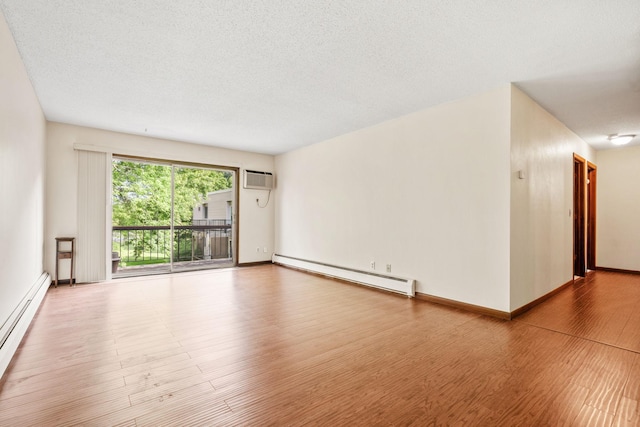 2801 Flag Ave N Unit 314, New Hope, MN 55427 - empty room featuring baseboard heating, wood finished floors, a textured ceiling, and a wall mounted air conditioner
