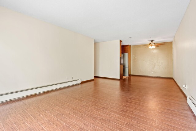 2801 Flag Ave N Unit 314, New Hope, MN 55427 - empty room with a ceiling fan, light wood-type flooring, and a baseboard heating unit