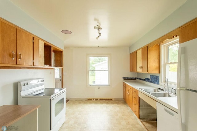 1820 5th St S, Moorhead, MN 56560 - kitchen with white appliances, healthy amount of natural light, light countertops, and light floors