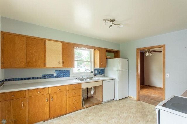 1820 5th St S, Moorhead, MN 56560 - kitchen with white appliances, light flooring, light countertops, brown cabinets, and ceiling fan