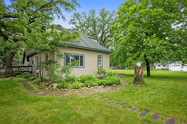 2606 Sessions St NW, Alexandria, MN 56308 - view of property exterior featuring a yard, roof with shingles, and a deck