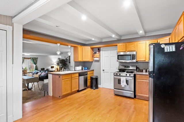 2606 Sessions St NW, Alexandria, MN 56308 - kitchen with stainless steel appliances, light wood-style floors, beamed ceiling, light countertops, and backsplash