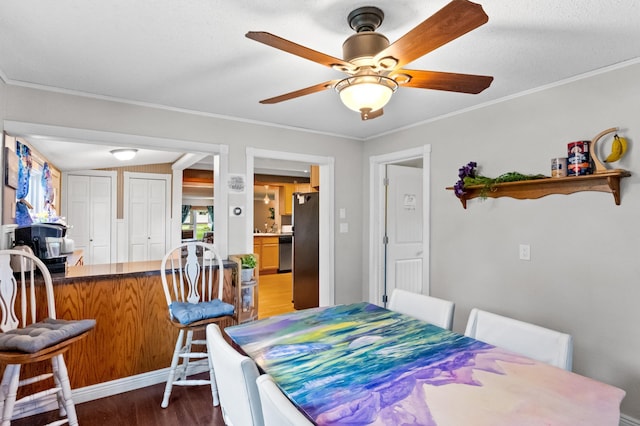 2606 Sessions St NW, Alexandria, MN 56308 - dining area with wood finished floors, a ceiling fan, and crown molding