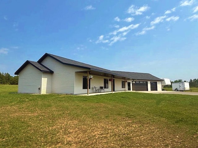 16696 Eclipse Dr, Park Rapids, MN 56470 - view of front facade with an attached garage, concrete driveway, a front lawn, and a patio