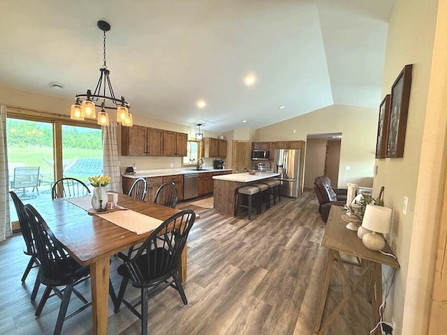 16696 Eclipse Dr, Park Rapids, MN 56470 - dining space with vaulted ceiling, dark wood-type flooring, and a chandelier