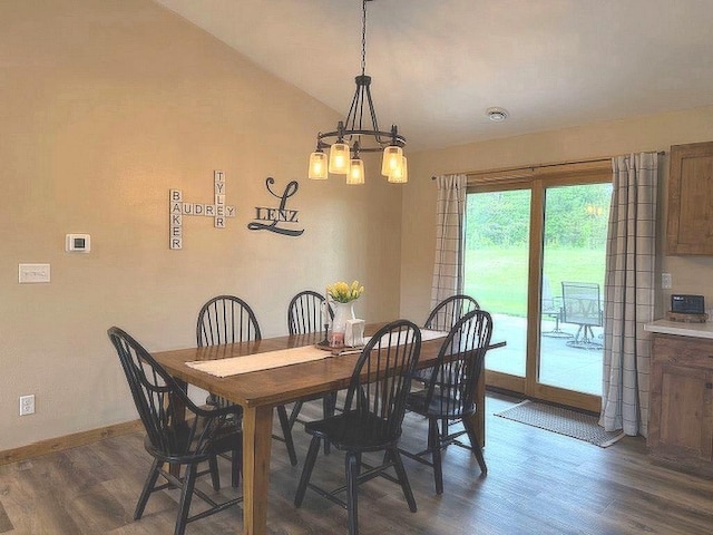 16696 Eclipse Dr, Park Rapids, MN 56470 - dining room with dark wood finished floors, a chandelier, and lofted ceiling