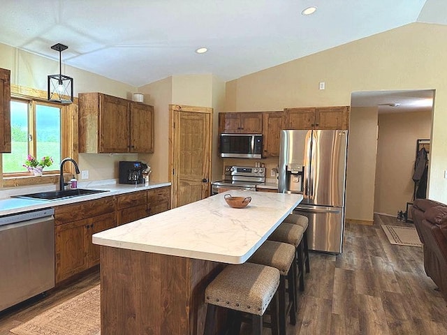 16696 Eclipse Dr, Park Rapids, MN 56470 - kitchen featuring stainless steel appliances, lofted ceiling, a kitchen island, light countertops, and dark wood finished floors