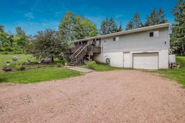 1388 13 1/2 Ave, Barron, WI 54812 - view of front facade with driveway, stairway, a garage, a front lawn, and a deck