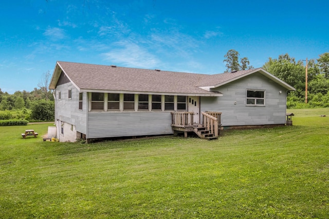 1388 13 1/2 Ave, Barron, WI 54812 - back of house with a shingled roof and a lawn