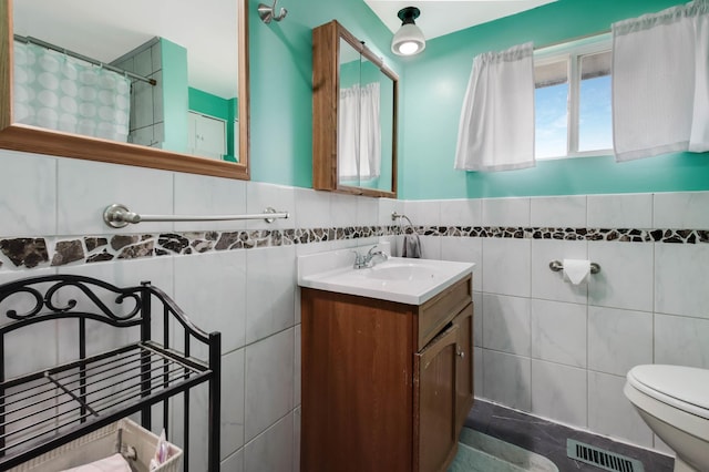 1388 13 1/2 Ave, Barron, WI 54812 - bathroom with tile walls, vanity, a shower with shower curtain, and a wainscoted wall