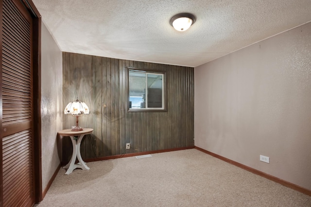 1388 13 1/2 Ave, Barron, WI 54812 - spare room featuring a textured ceiling, carpet, and wood walls