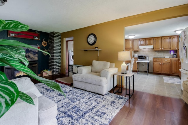 1388 13 1/2 Ave, Barron, WI 54812 - living area with washer / clothes dryer and light wood-style flooring