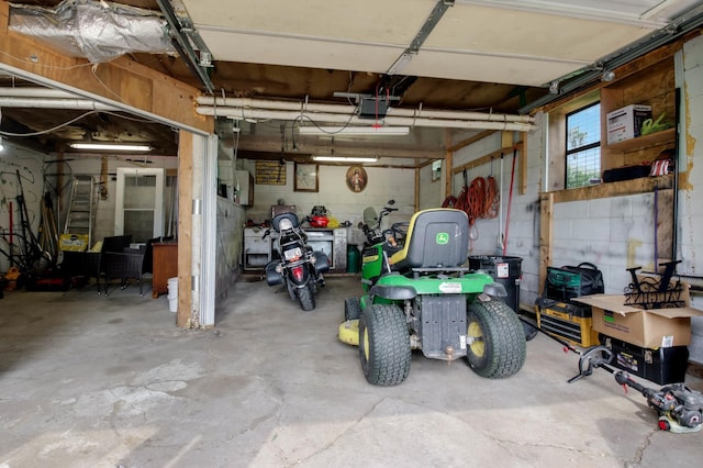 1388 13 1/2 Ave, Barron, WI 54812 - garage featuring a garage door opener and concrete block wall