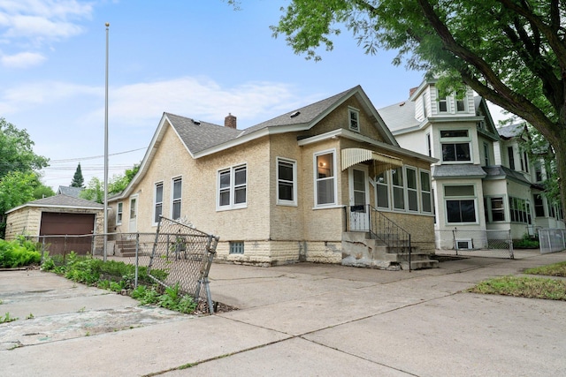 693 Bedford St, Saint Paul, MN 55130 - view of front of house featuring a shingled roof and an outbuilding
