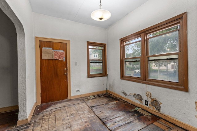 693 Bedford St, Saint Paul, MN 55130 - entryway with hardwood / wood-style floors, arched walkways, and a textured wall