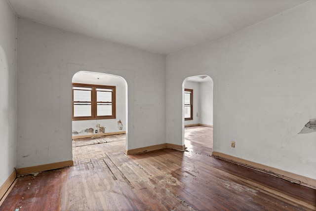 693 Bedford St, Saint Paul, MN 55130 - spare room featuring arched walkways and hardwood / wood-style floors