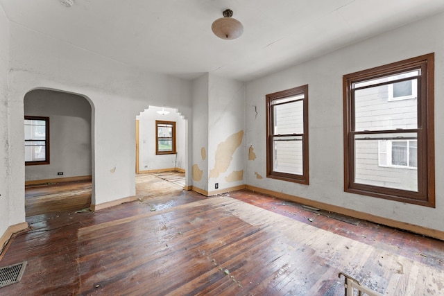 693 Bedford St, Saint Paul, MN 55130 - spare room featuring hardwood / wood-style floors, arched walkways, and healthy amount of natural light