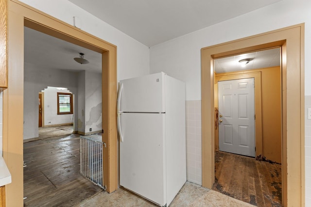 693 Bedford St, Saint Paul, MN 55130 - kitchen with freestanding refrigerator, arched walkways, and wood finished floors