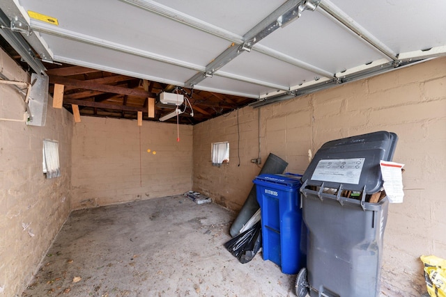 693 Bedford St, Saint Paul, MN 55130 - garage featuring a garage door opener and concrete block wall