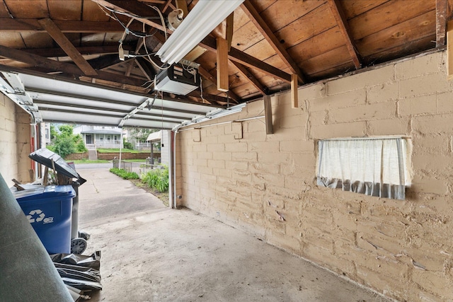 693 Bedford St, Saint Paul, MN 55130 - garage featuring a garage door opener and concrete block wall