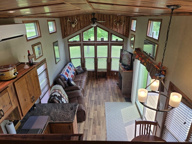 20389 640th Ln, Jacobson, MN 55752 - living room featuring a wall unit AC, ceiling fan, wood finished floors, plenty of natural light, and lofted ceiling