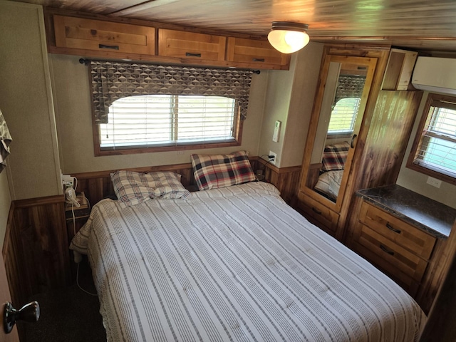 20389 640th Ln, Jacobson, MN 55752 - bedroom with a wainscoted wall and an AC wall unit