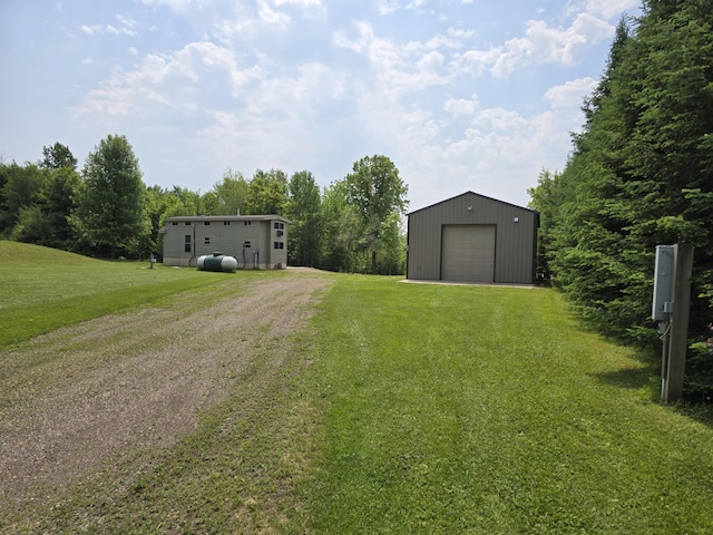 20389 640th Ln, Jacobson, MN 55752 - view of grassy yard with driveway, an outdoor structure, and a garage