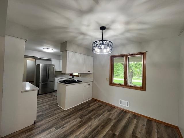 200 Amsterdam Ave E, Hollandale, MN 56045 - kitchen with freestanding refrigerator, a peninsula, white cabinets, dark wood finished floors, and a chandelier