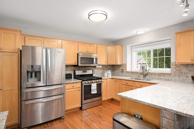 10787 Alison Way, Inver Grove Heights, MN 55077 - kitchen featuring appliances with stainless steel finishes, light brown cabinets, light wood-style flooring, and tasteful backsplash
