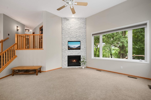 10787 Alison Way, Inver Grove Heights, MN 55077 - unfurnished living room with carpet, a ceiling fan, a fireplace, and stairs