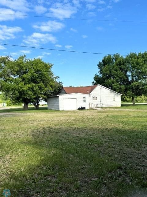 857 Main St, Mahnomen, MN 56557 - view of green lawn featuring a garage