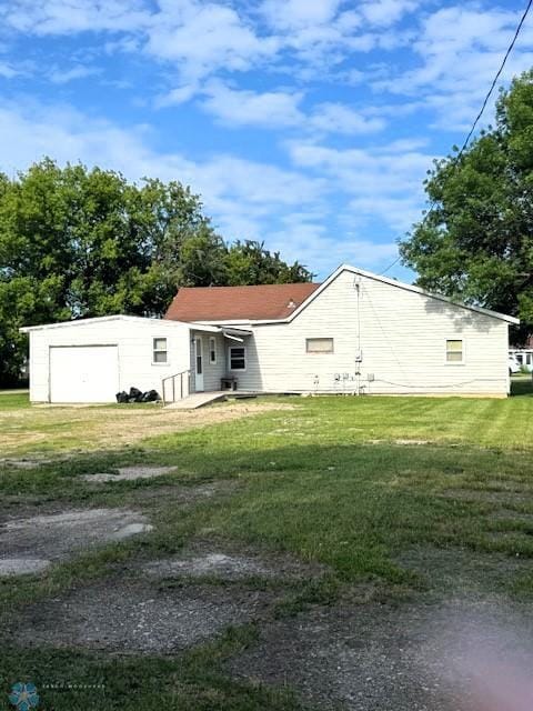 857 Main St, Mahnomen, MN 56557 - rear view of property with a lawn and a garage