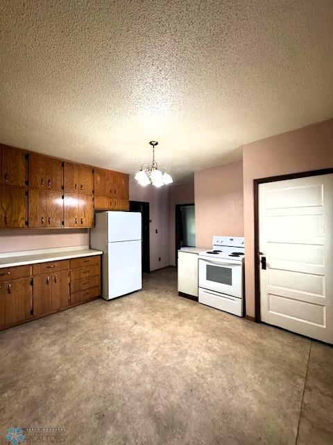 857 Main St, Mahnomen, MN 56557 - kitchen featuring white appliances, a chandelier, brown cabinets, a textured ceiling, and light countertops